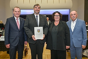 Gruppenfoto mit dem neu gewählten Alexander Heppe. Er hält seine Ernennungsurkunde.