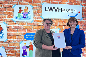 Die Hessische Sozialministerin Heike Hofmann (r.) überreicht den Bewilligungsbescheid an LWV-Landesdirektorin Susanne Simmler. (Foto: Bernd Bark)